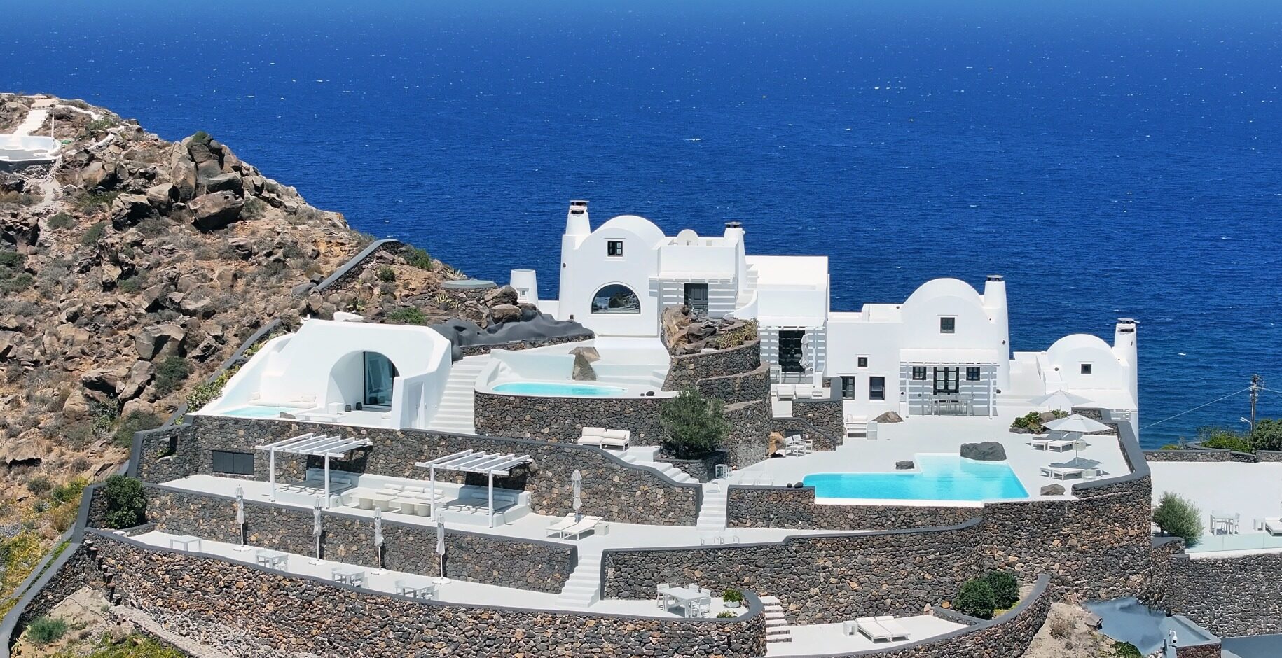 Aenaon Villas is one of Santorini's best luxury hotels and top places to stay in 2026. Located at the island’s highest point between Oia and Imerovigli, featuring private cliffside villas, caldera-edge infinity pools, white minimalist architecture, and uninterrupted panoramic views of the Aegean Sea and volcanic caldera.