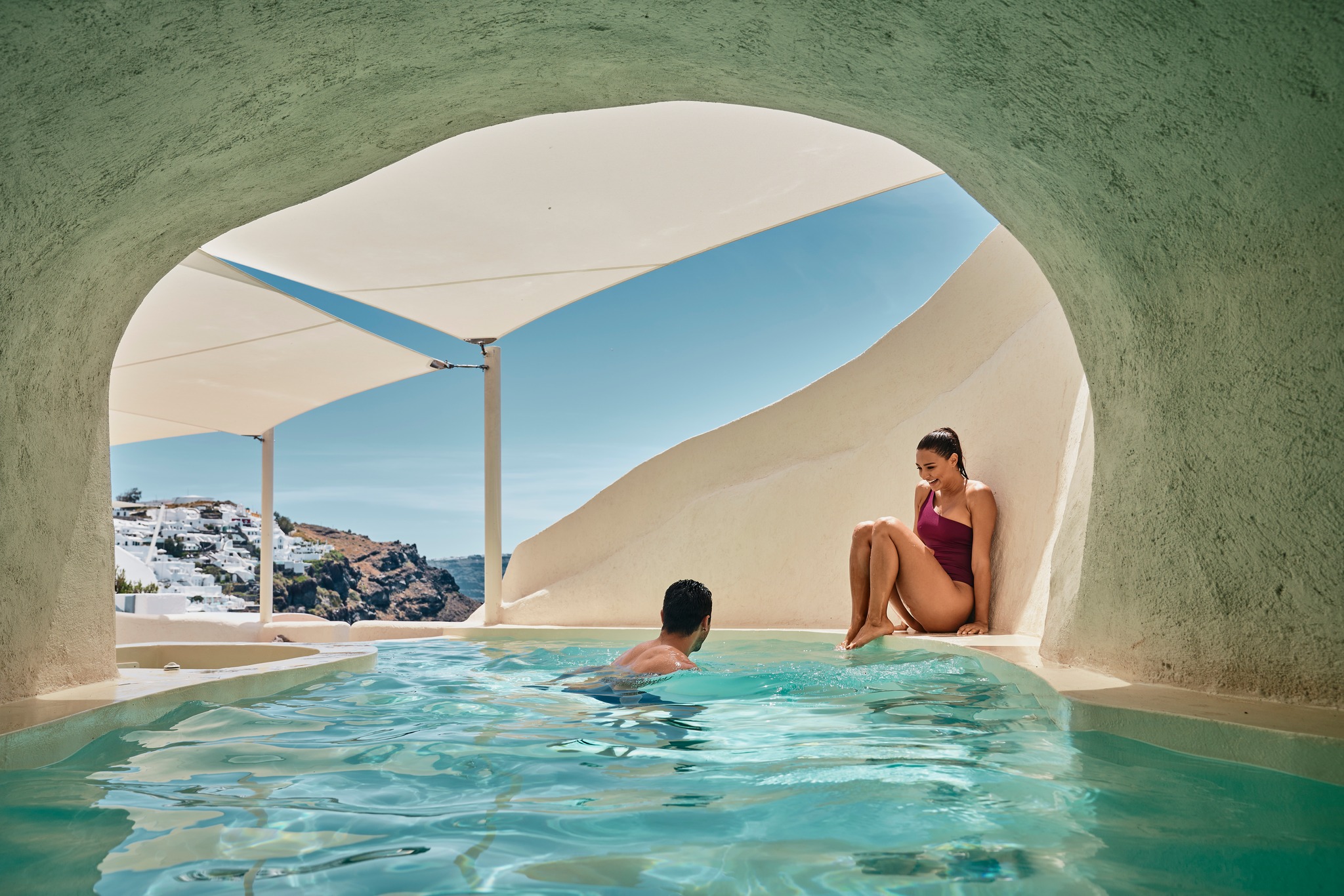 Luxury cave hotel in Santorini featuring a private cave pool, caldera views, and hand-carved suites set into the volcanic cliffs above the Aegean Sea.