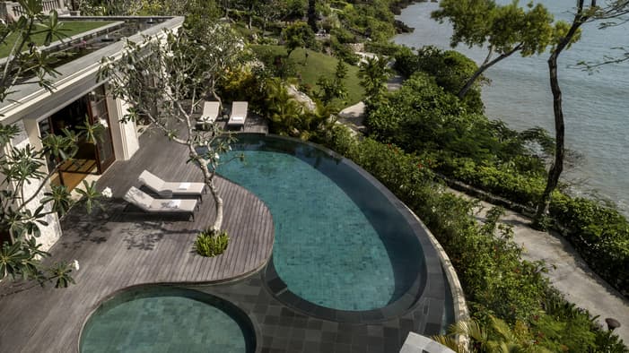 Luxury pool villa at Four Seasons Resort Jimbaran Bay in Bali with private plunge pool, outdoor terrace, and ocean views overlooking Jimbaran’s crescent bay; premium five-star beachfront resort with modern natural interiors.