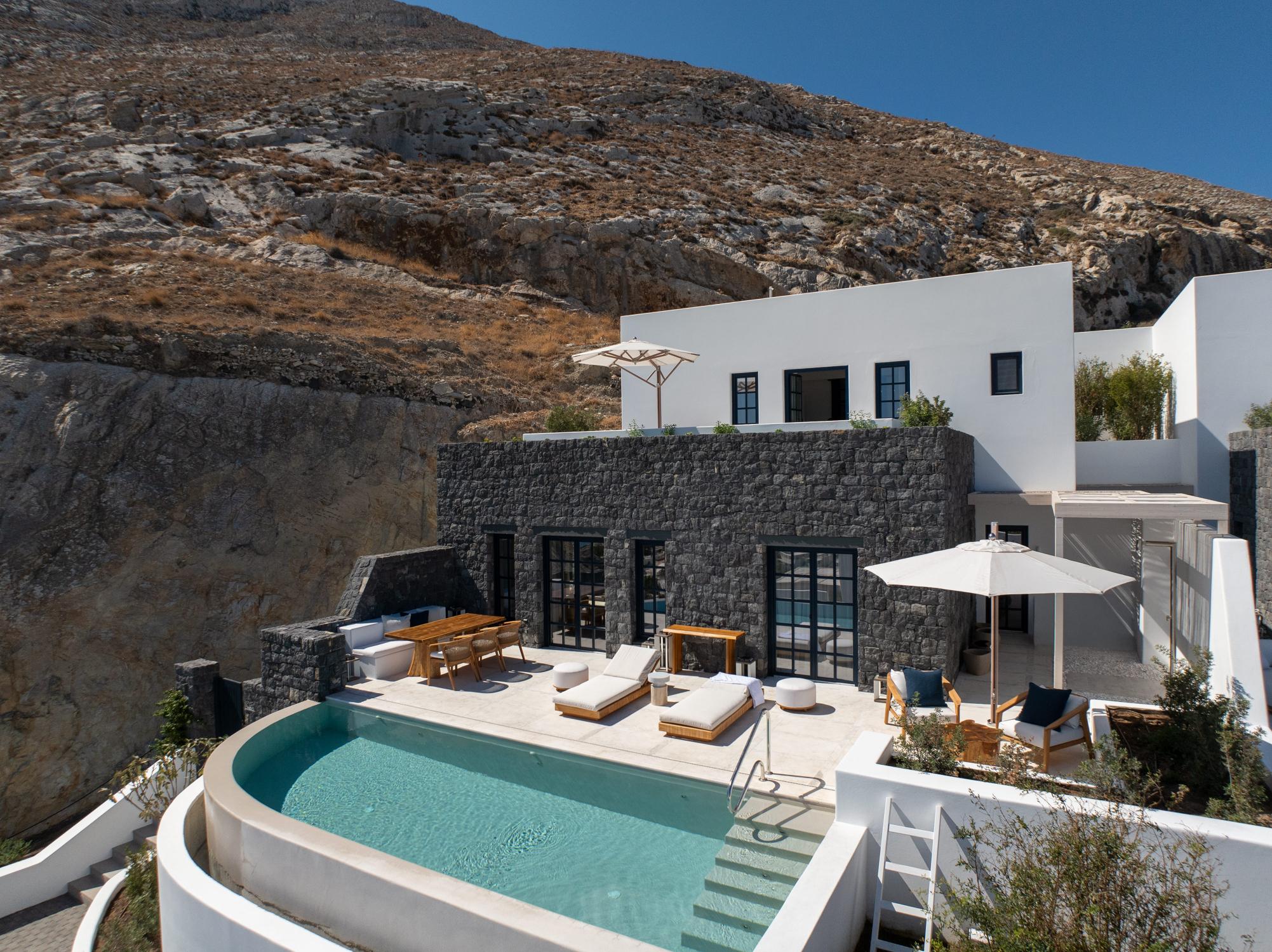 Sandblu Santorini luxury resort villa with private infinity pool, modern Cycladic architecture, and panoramic open-sea views above Kamari.