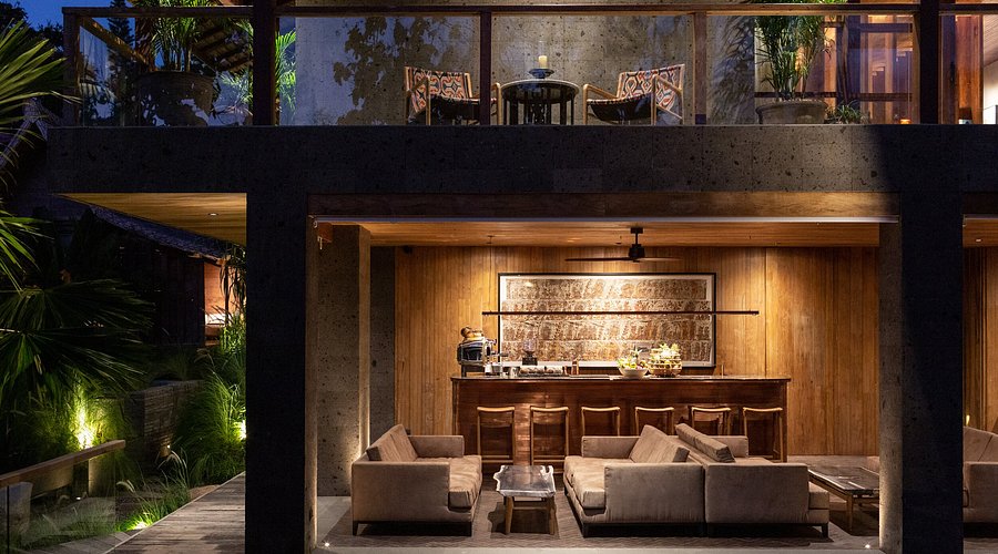Luxury wellness suite at The Asa Maia in Uluwatu, Bali, featuring modern architectural design, open-air lounge, natural wood interiors, private terrace seating, and a low-density boutique retreat setting designed for yoga and holistic wellness stays.