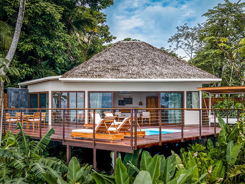 Eco-luxury lodge on the Osa Peninsula with stilted bungalows, rainforest and Pacific views, hardwood interiors, decks with hammocks, and guided wildlife experiences.