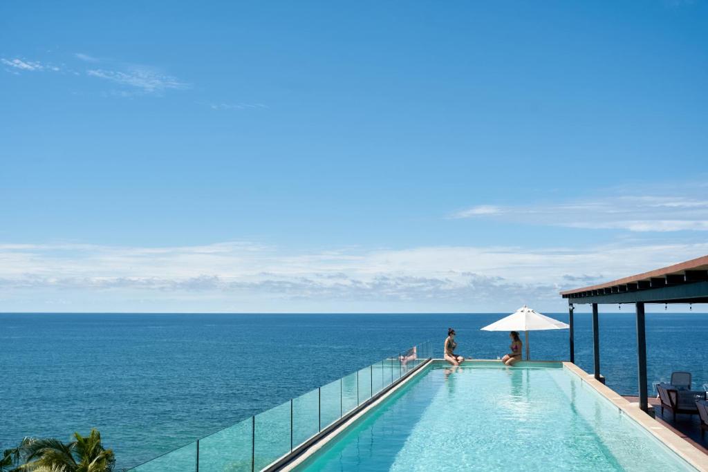 Hotel Basalto near Punta Mita with ten contemporary suites, oceanview terraces, plunge pools, minimalist architecture, and a modern pool overlooking Litibú Beach in Riviera Nayarit.