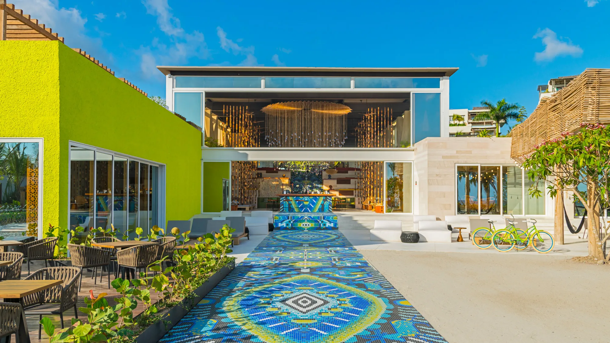 W Punta de Mita entrance with Huichol-inspired mosaic walkway, contemporary design, and open-air lobby facing the Pacific Ocean; a modern Punta Mita resort in Riviera Nayarit.