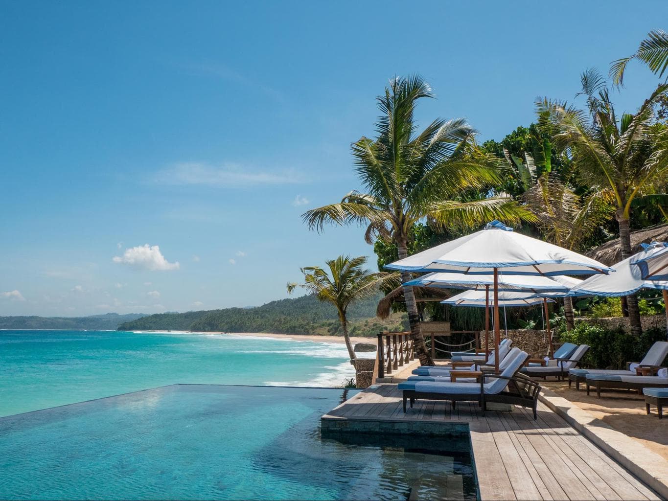 Oceanfront infinity pool and rustic-luxury villas at NIHI Sumba near Bali in Indonesia, a remote five-star boutique beach resort with private pools, horseback riding on the sand, world-class surfing, and immersive wellness retreats